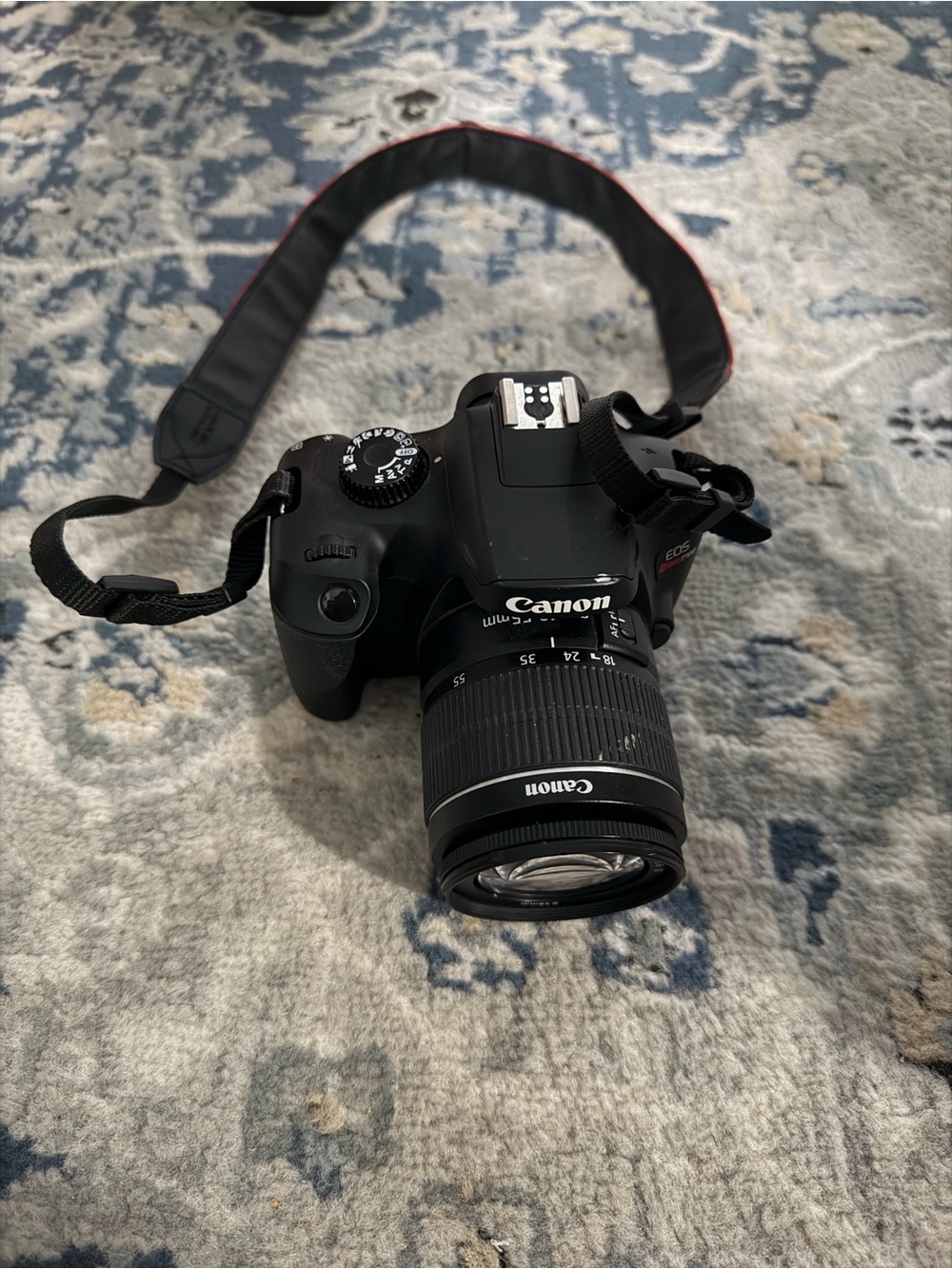 Canon EOS RebelT100 DSLR Camera with Kit Zoom Lens and Red-Trim Strap